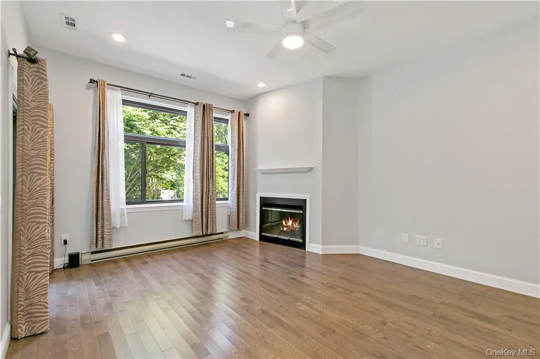 Sunken Living Room with Wood Burning Fireplace, High Ceiling and Sliding Glass Door to Balcony Sunken Living Room with Wood Burning Fireplace, High Ceiling and Sliding Glass Door to Balcony