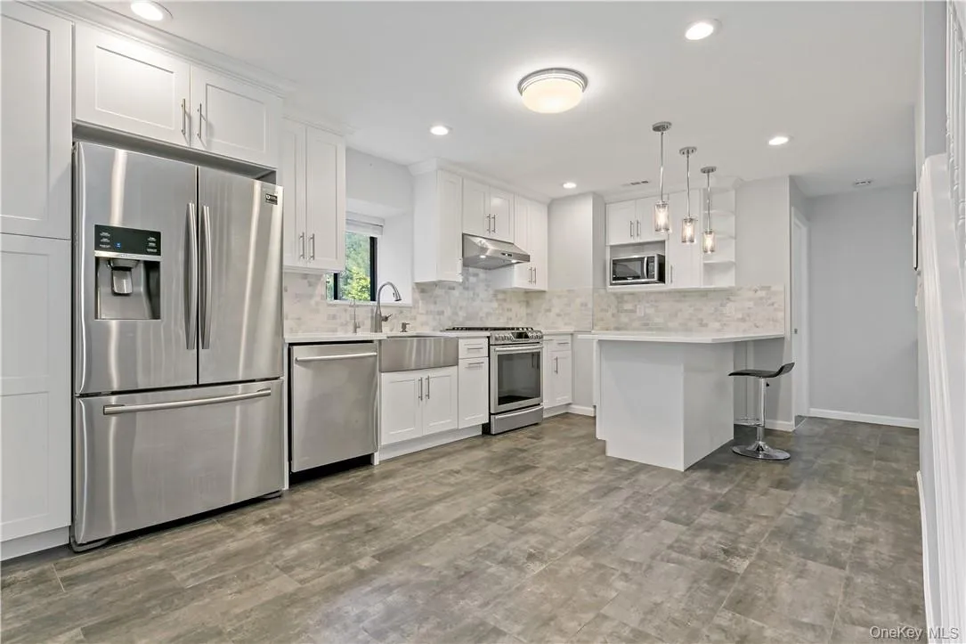 Renovated Eat-In-Kitchen with Quartz Countertops and Stainless Steel Appliances Renovated Eat-In-Kitchen with Quartz Countertops and Stainless Steel Appliances