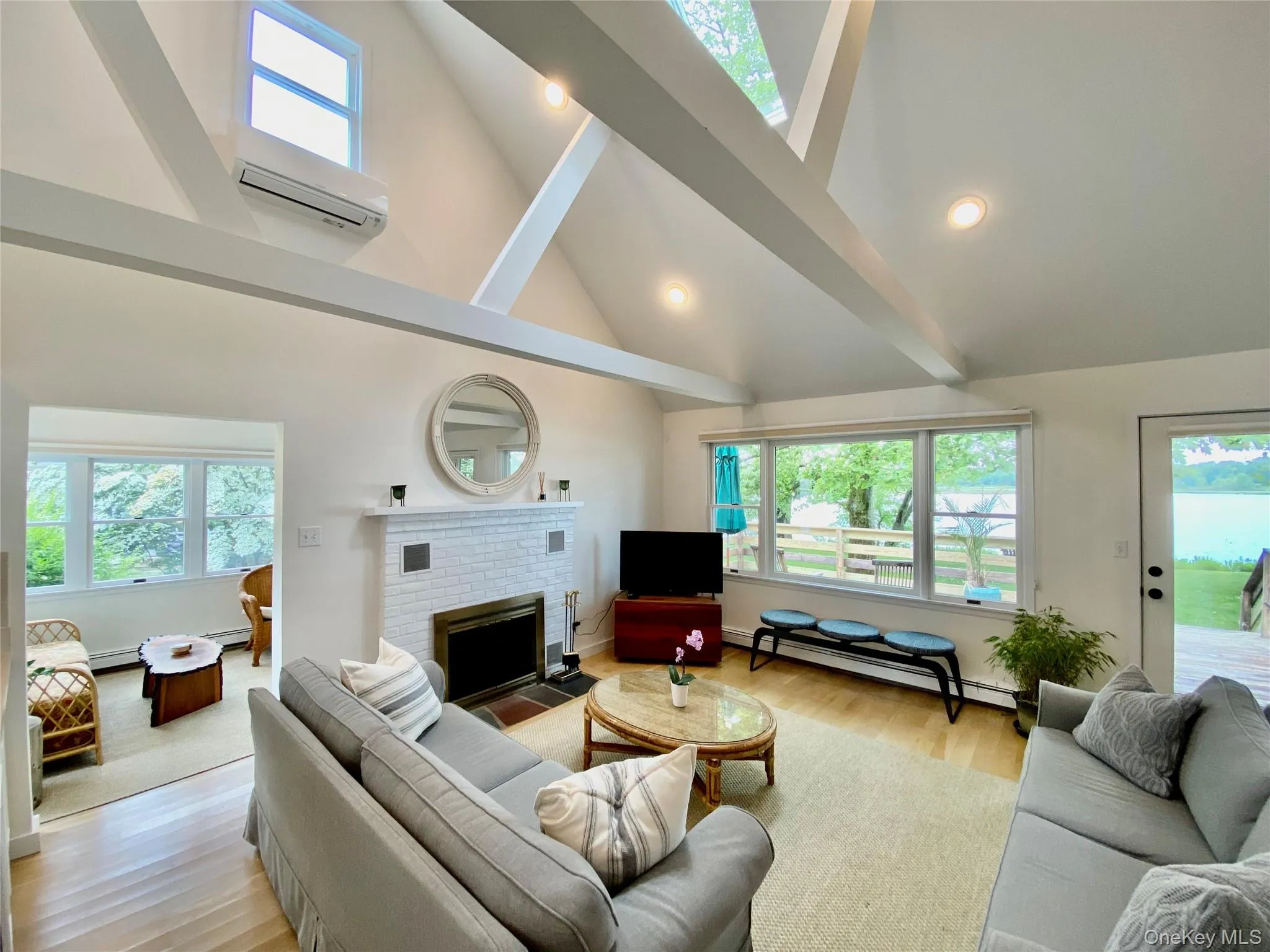 Vaulted ceiling in the living room with a beautiful view of the pond Vaulted ceiling in the living room with a beautiful view of the pond