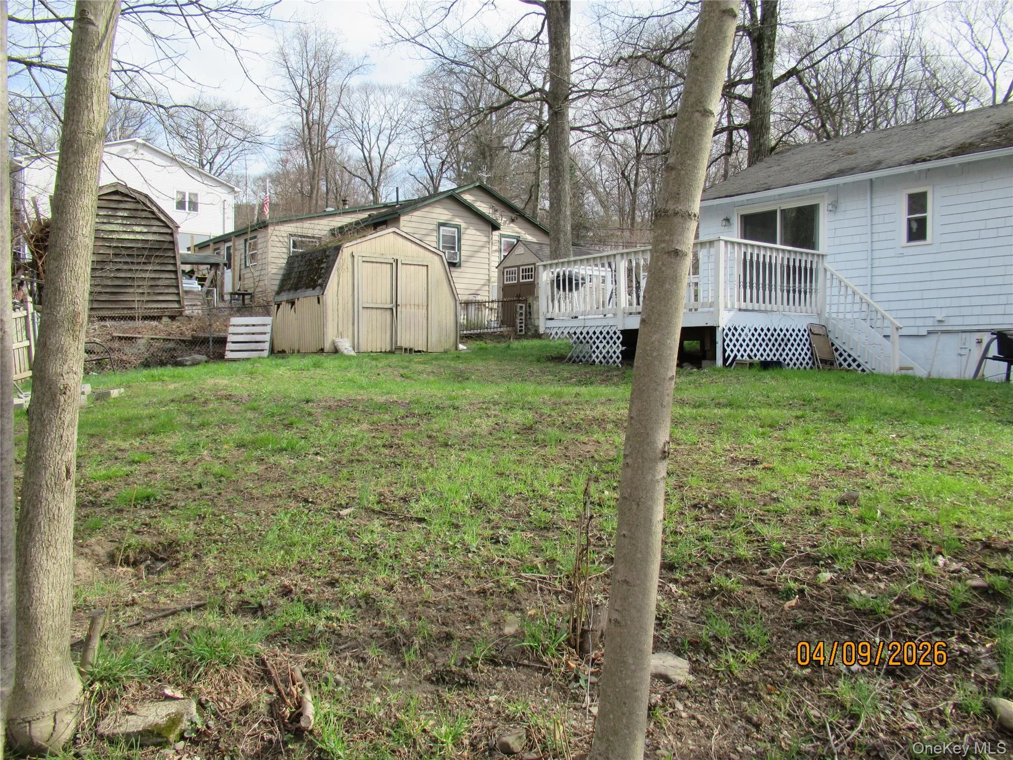 The property features a spacious yard with grass The property features a spacious yard with grass