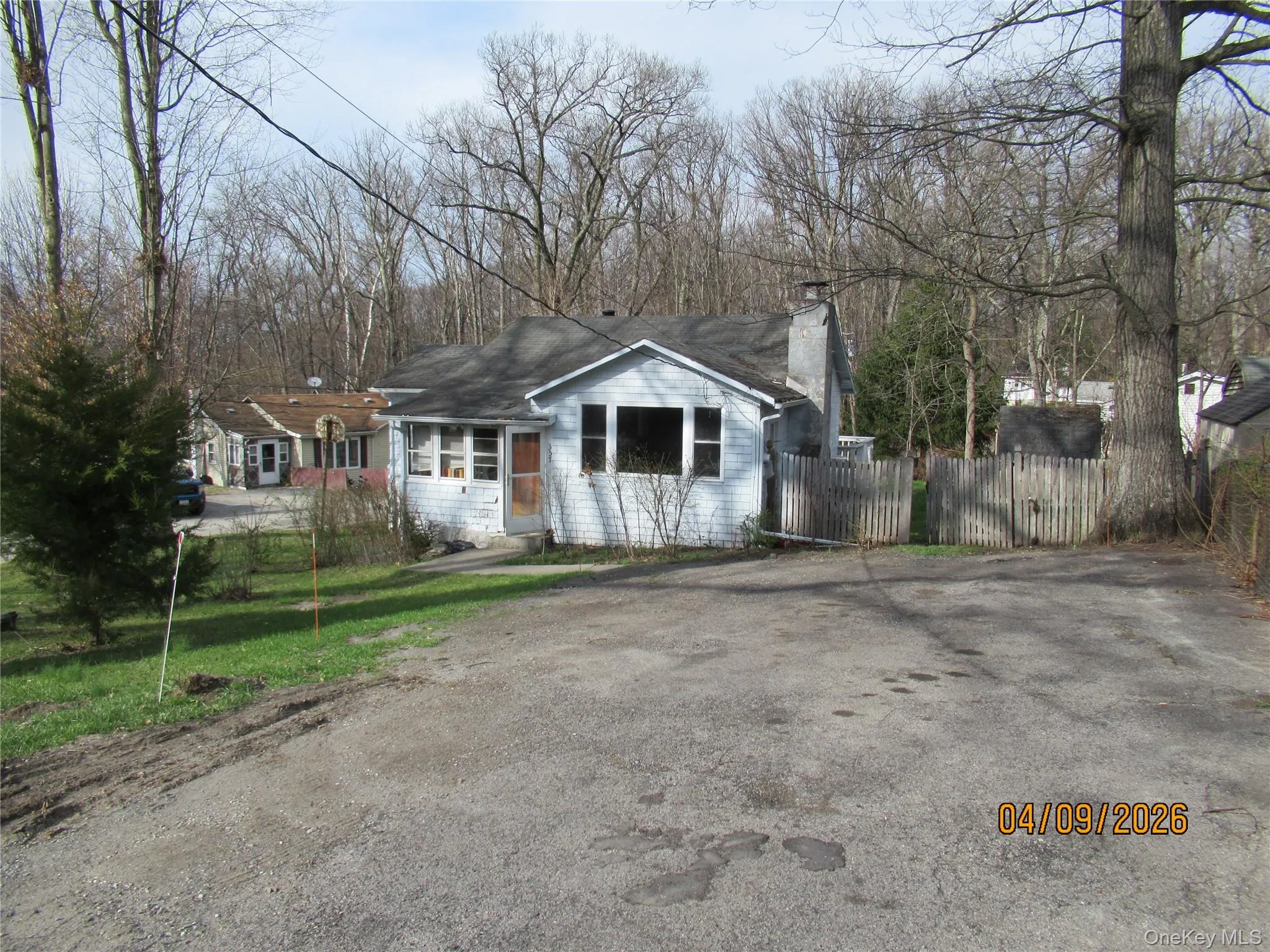 The property features a single-story residence with a light-colored exterior The property features a single-story residence with a light-colored exterior