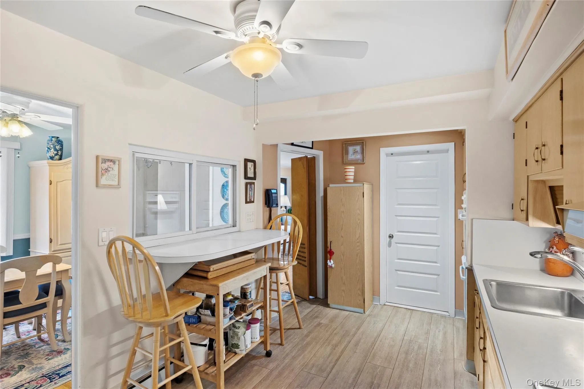 Eat in kitchen with light wood-style flooring Eat in kitchen with light wood-style flooring