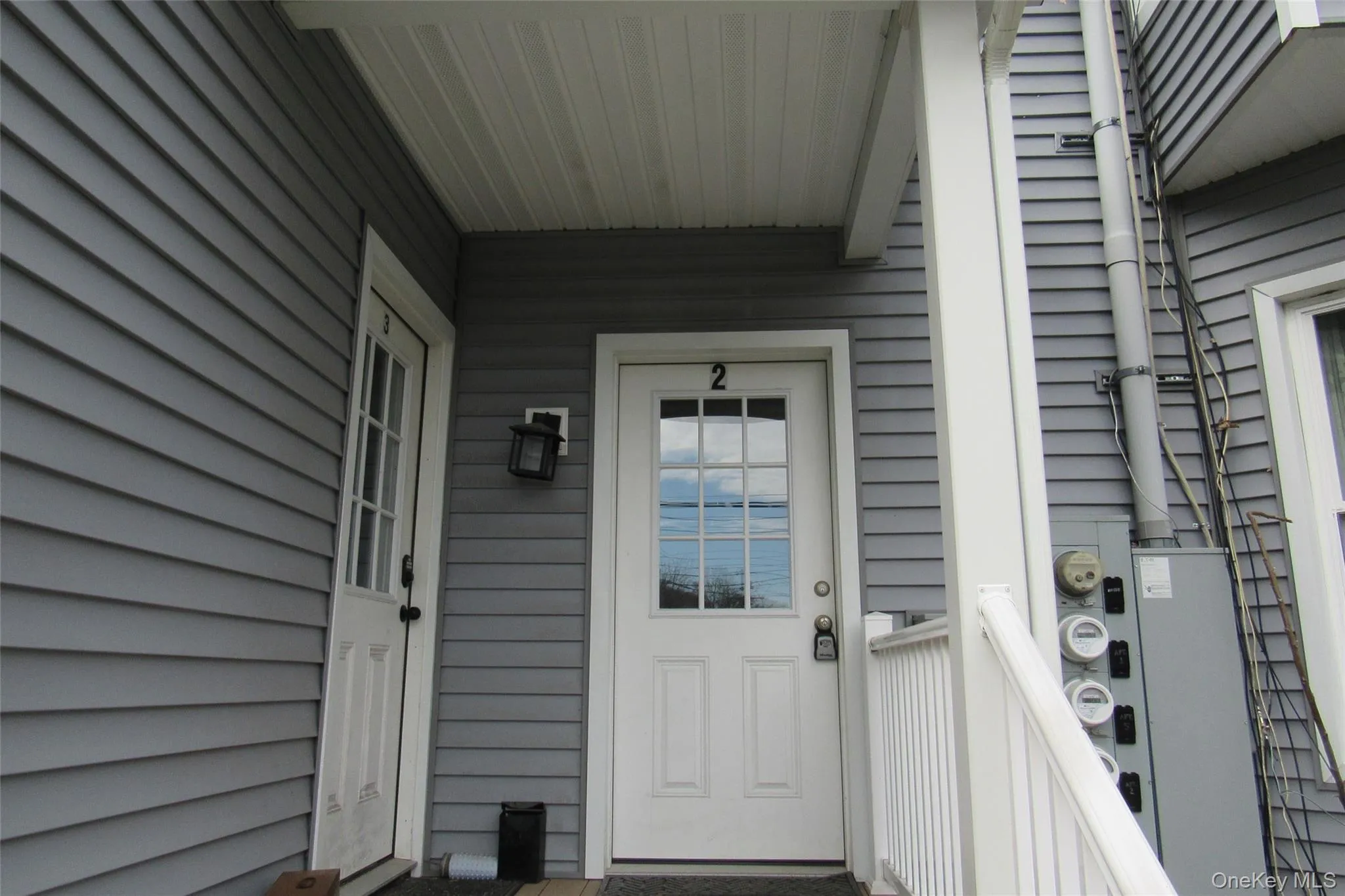 Gray horizontal siding exterior with white trim and white entry door Gray horizontal siding exterior with white trim and white entry door
