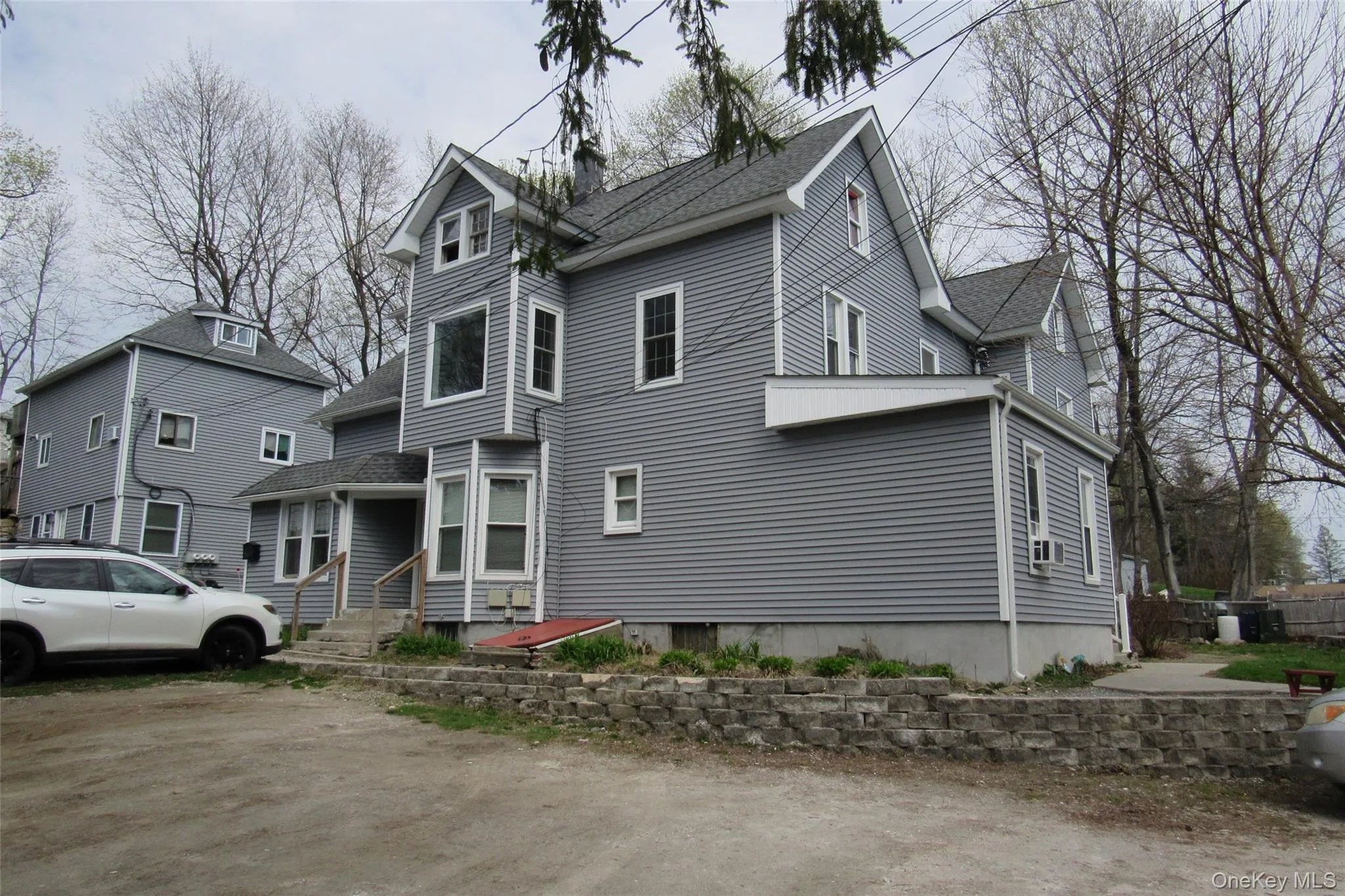 Multi-story structure featuring light gray siding with white trim Multi-story structure featuring light gray siding with white trim
