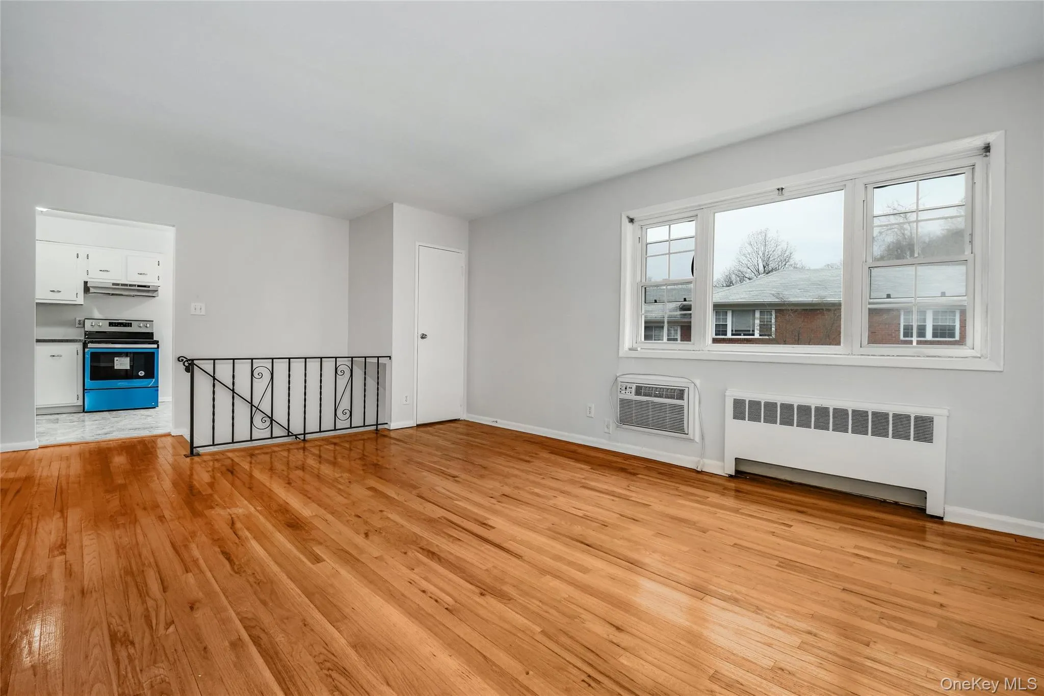 Living Room with HW Floors & Wall AC & Coat Closet Living Room with HW Floors & Wall AC & Coat Closet