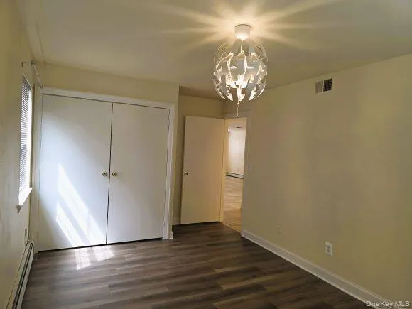Master bedroom features wood-look LVP flooring, a window with blinds, master bathroom, closets and direct access to rear patio. Master bedroom features wood-look LVP flooring, a window with blinds, master bathroom, closets and direct access to rear patio.