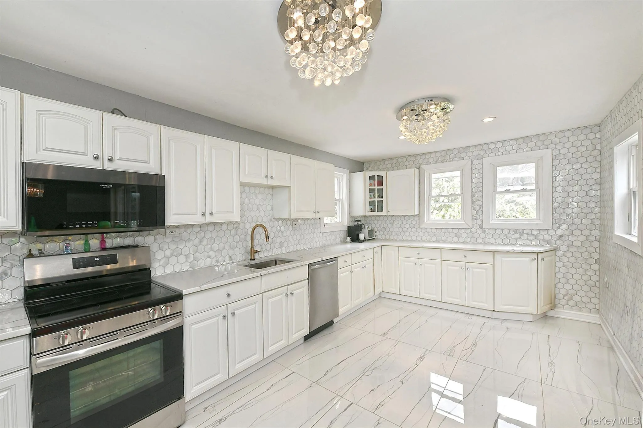 Bright kitchen with quartz countertops and stainless steel appliances. Bright kitchen with quartz countertops and stainless steel appliances.