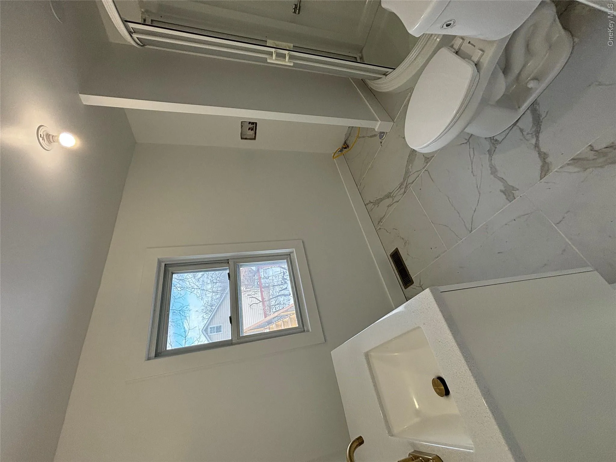 Bathroom featuring vanity, light marble finish floors, and a stall shower Bathroom featuring vanity, light marble finish floors, and a stall shower