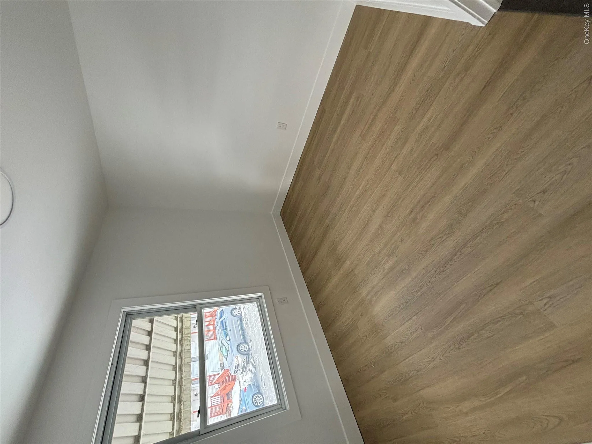 Unfurnished room with baseboards and wood finished floors Unfurnished room with baseboards and wood finished floors