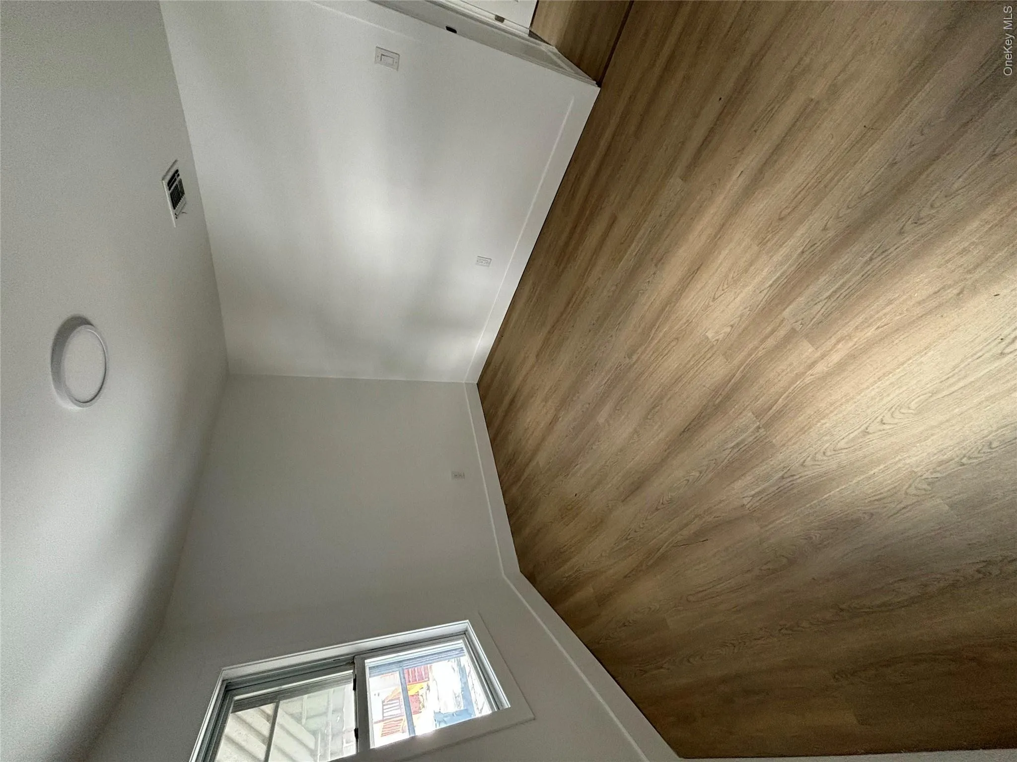 Unfurnished room with wood finished floors and baseboards Unfurnished room with wood finished floors and baseboards