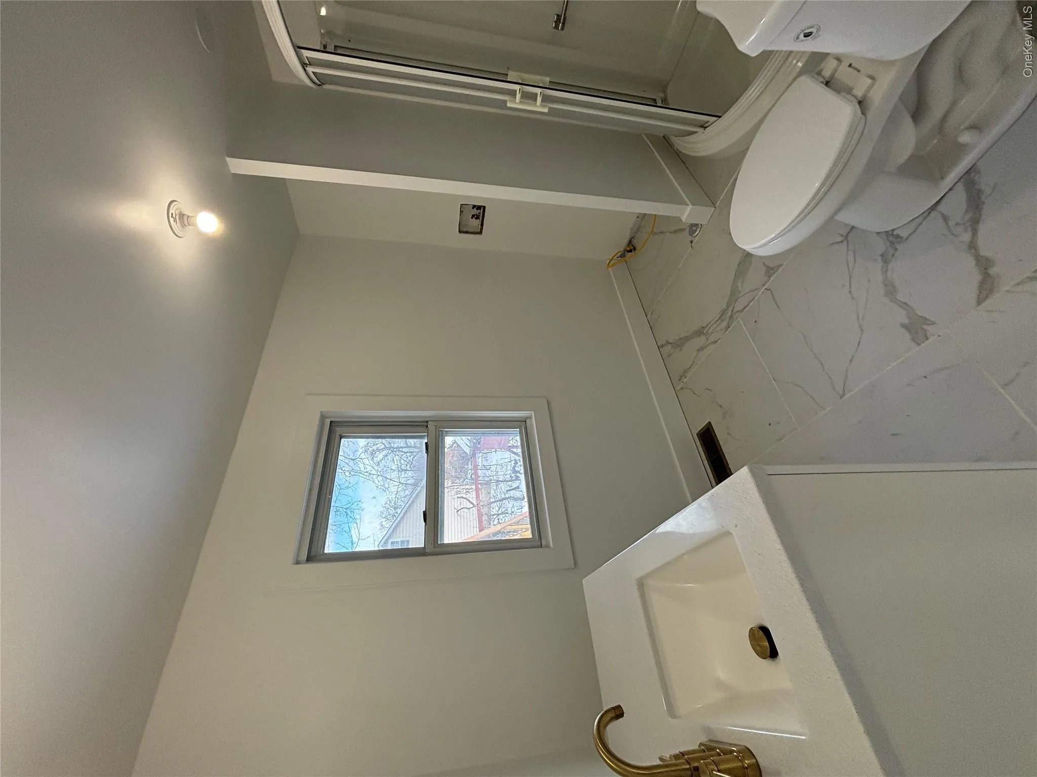 Full bathroom with vanity, light marble finish floors, and a shower stall Full bathroom with vanity, light marble finish floors, and a shower stall