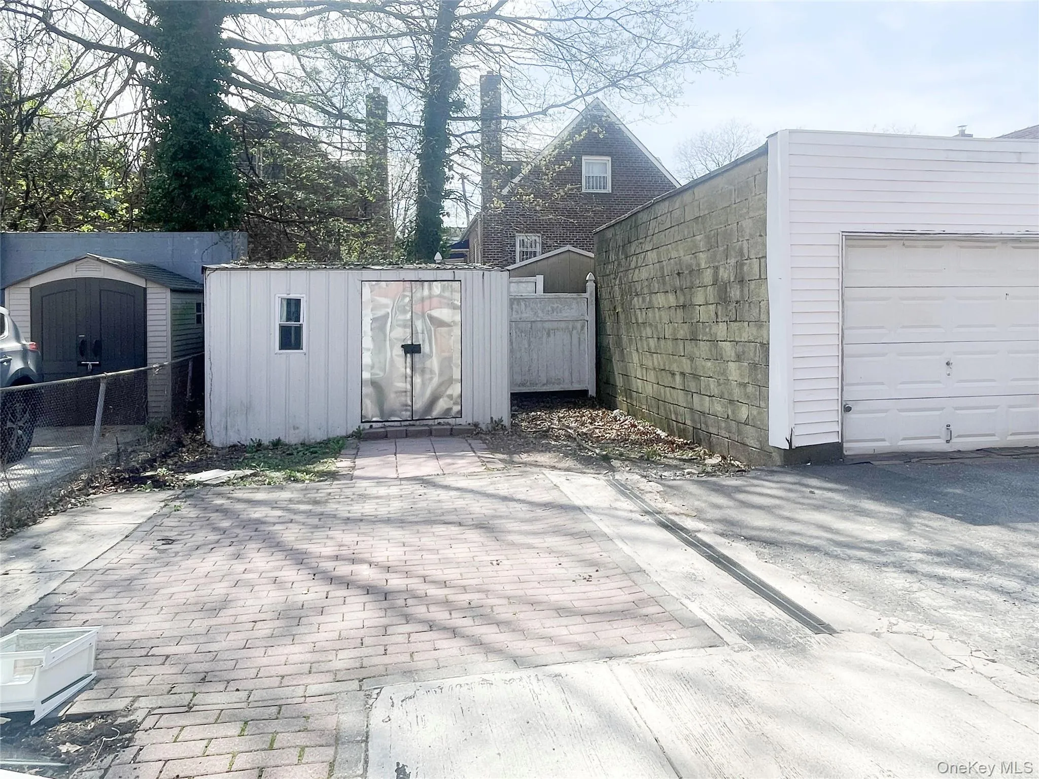 Paved Back yard can fit two vehicles. Also a Shed for additional storage Paved Back yard can fit two vehicles. Also a Shed for additional storage