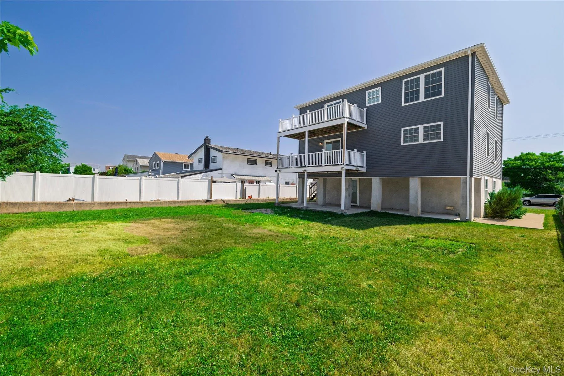 Rear exterior featuring dark gray siding and white trim Rear exterior featuring dark gray siding and white trim