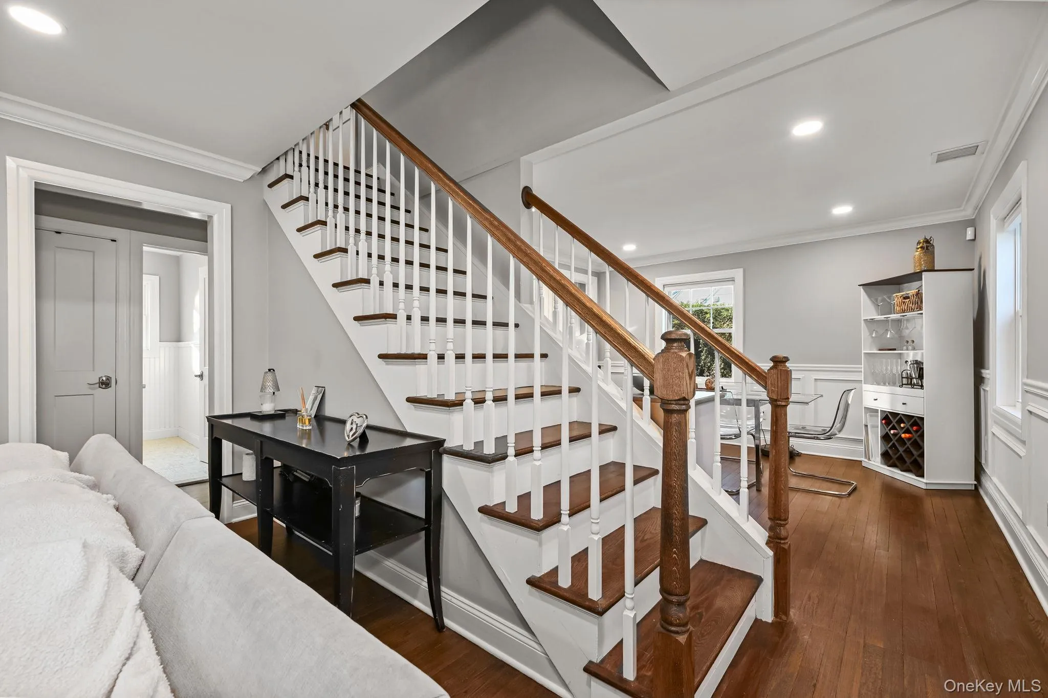 An elegant staircase leads to the upper level, where two additional bedrooms and a full bathroom await. An elegant staircase leads to the upper level, where two additional bedrooms and a full bathroom await.