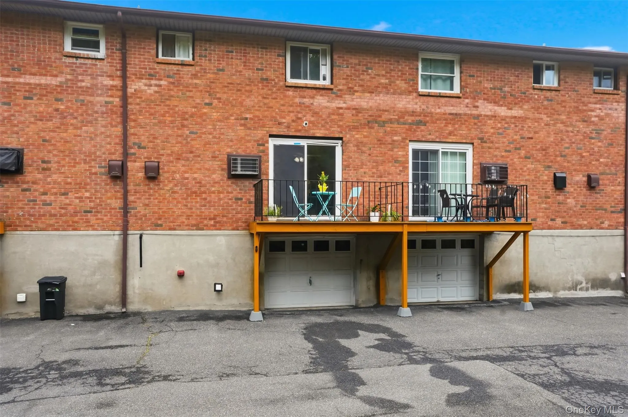 Brick exterior featuring two ground-level garage doors Brick exterior featuring two ground-level garage doors