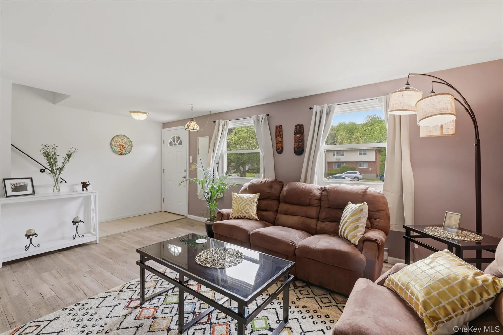 Living area multiple windows, and a front entry door with a decorative glass insert Living area multiple windows, and a front entry door with a decorative glass insert