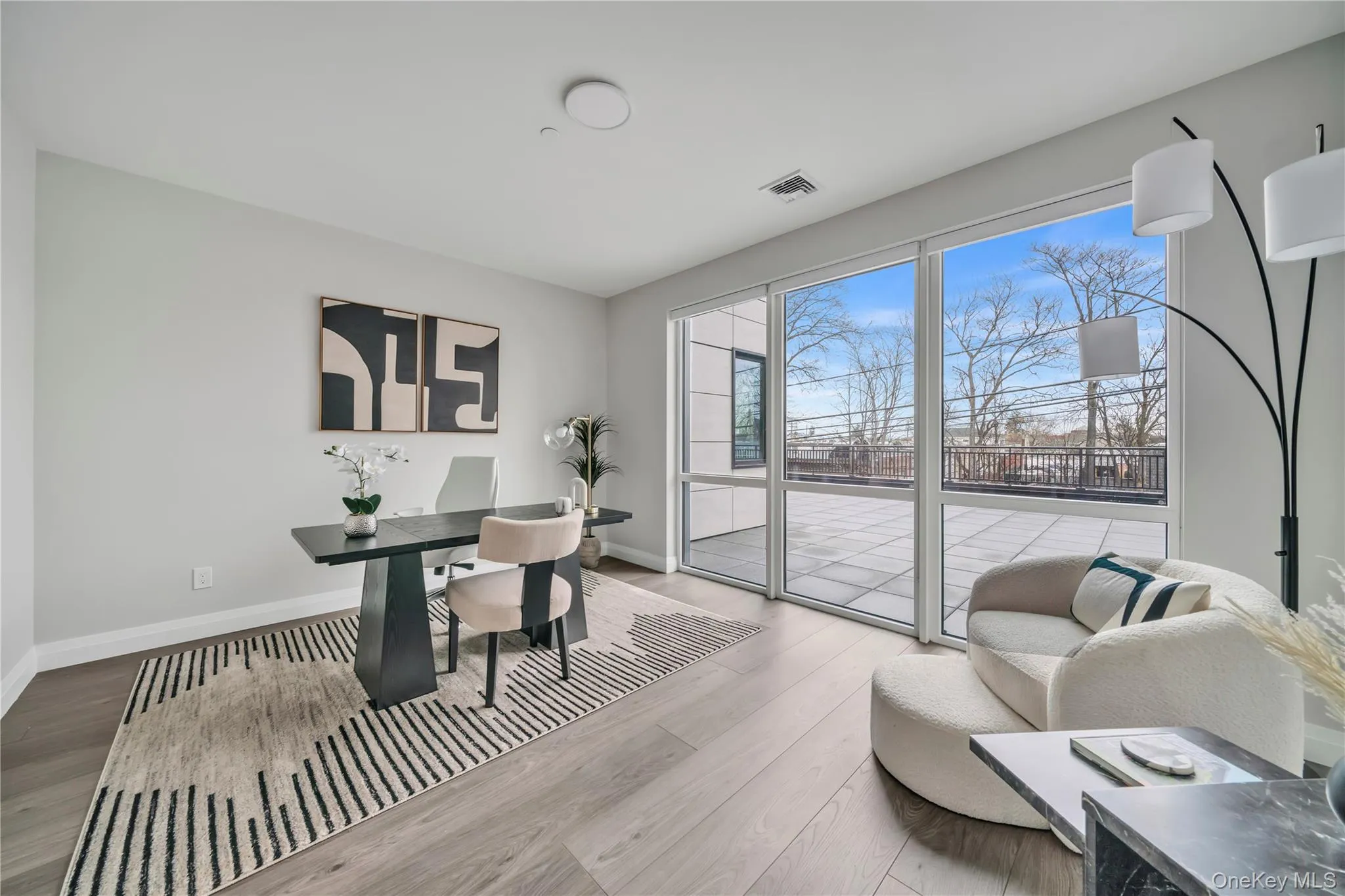 Office area with visible vents, baseboards, and wood finished floors Office area with visible vents, baseboards, and wood finished floors