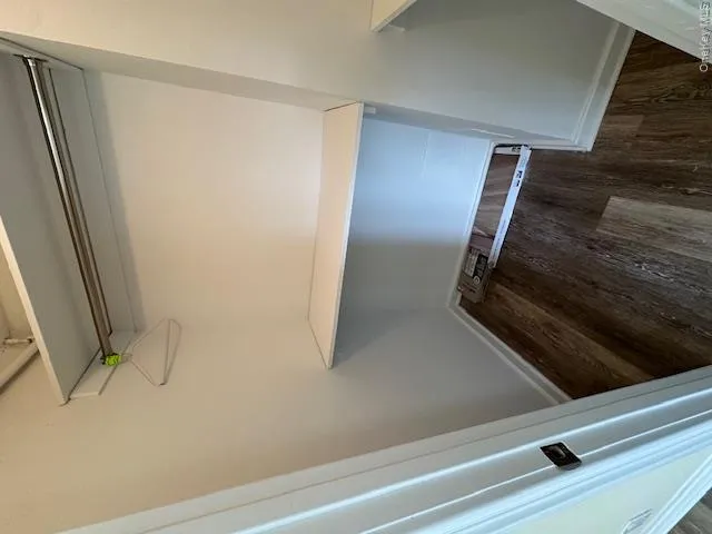 Walk in closet with wood finished floors Walk in closet with wood finished floors