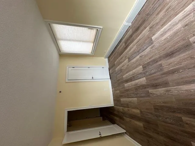 Spare room with baseboards, a textured ceiling, and dark wood finished floors Spare room with baseboards, a textured ceiling, and dark wood finished floors