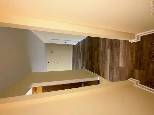 Hallway featuring wood finished floors and baseboards Hallway featuring wood finished floors and baseboards