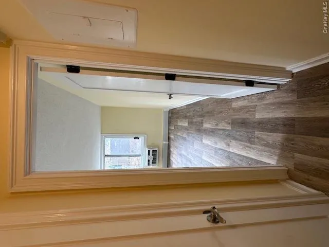Corridor with dark wood-style flooring, baseboards, electric panel, and a textured ceiling Corridor with dark wood-style flooring, baseboards, electric panel, and a textured ceiling