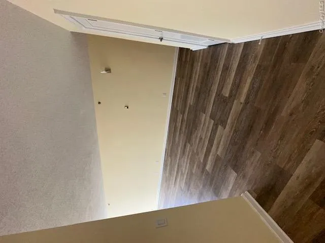 Spare room featuring dark wood-type flooring, baseboards, and a textured ceiling Spare room featuring dark wood-type flooring, baseboards, and a textured ceiling