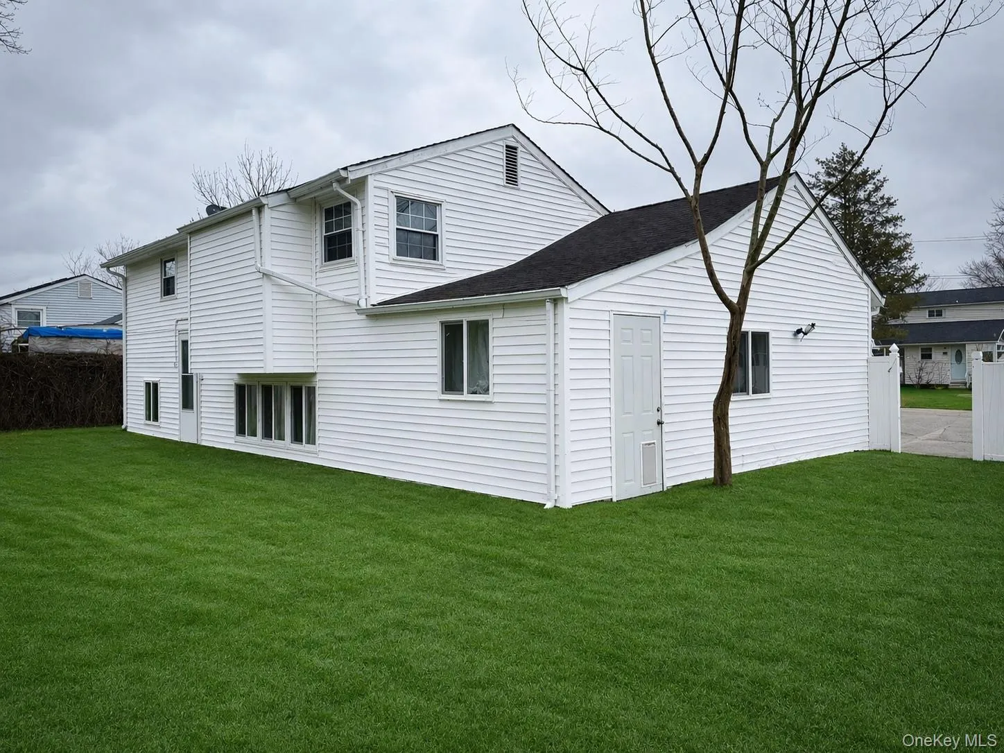 White horizontal siding exterior with a dark shingle roof White horizontal siding exterior with a dark shingle roof