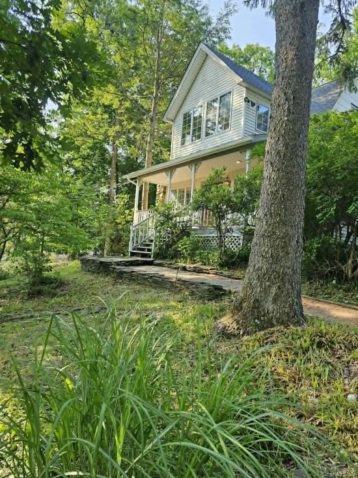 Front of house with perennials grown in which come back year after year Front of house with perennials grown in which come back year after year