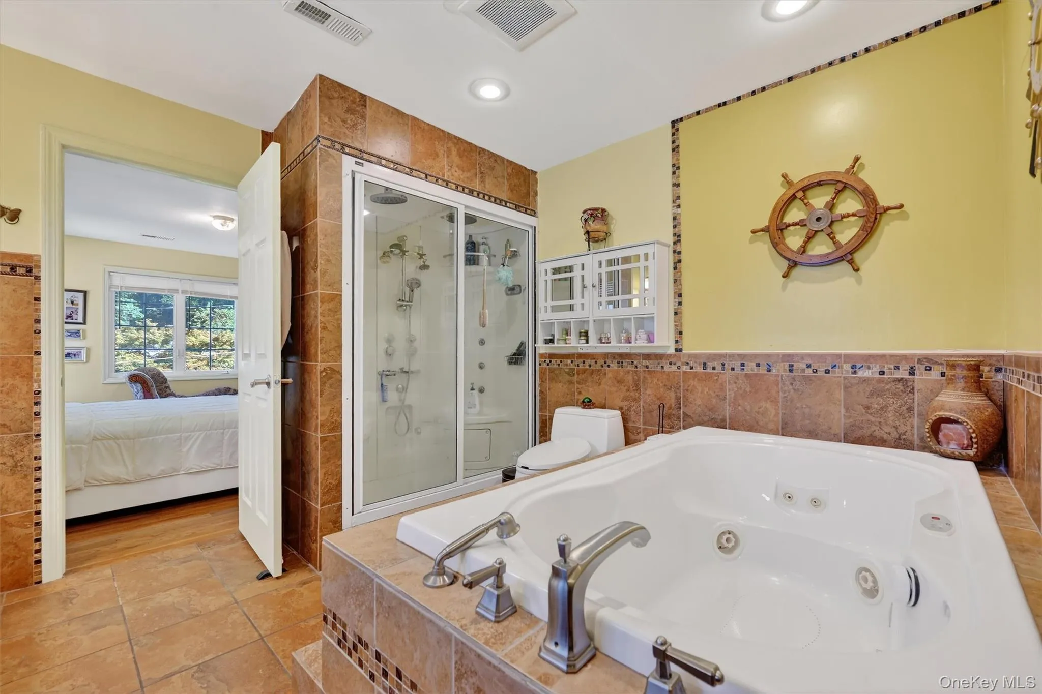 Full bathroom with a shower stall, a jetted tub, ensuite bath, and recessed lighting Full bathroom with a shower stall, a jetted tub, ensuite bath, and recessed lighting