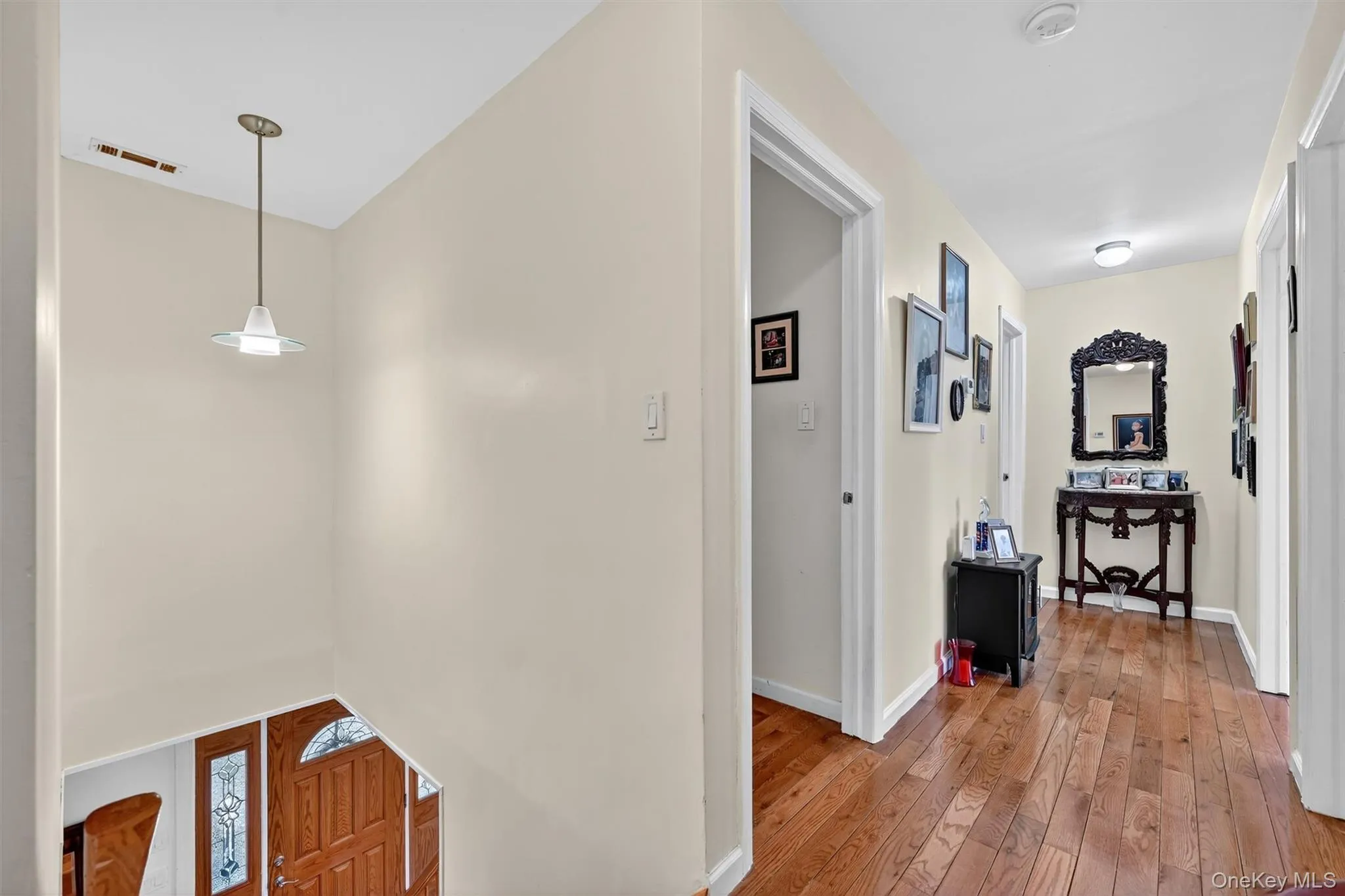 Corridor with light wood-type flooring and baseboards Corridor with light wood-type flooring and baseboards
