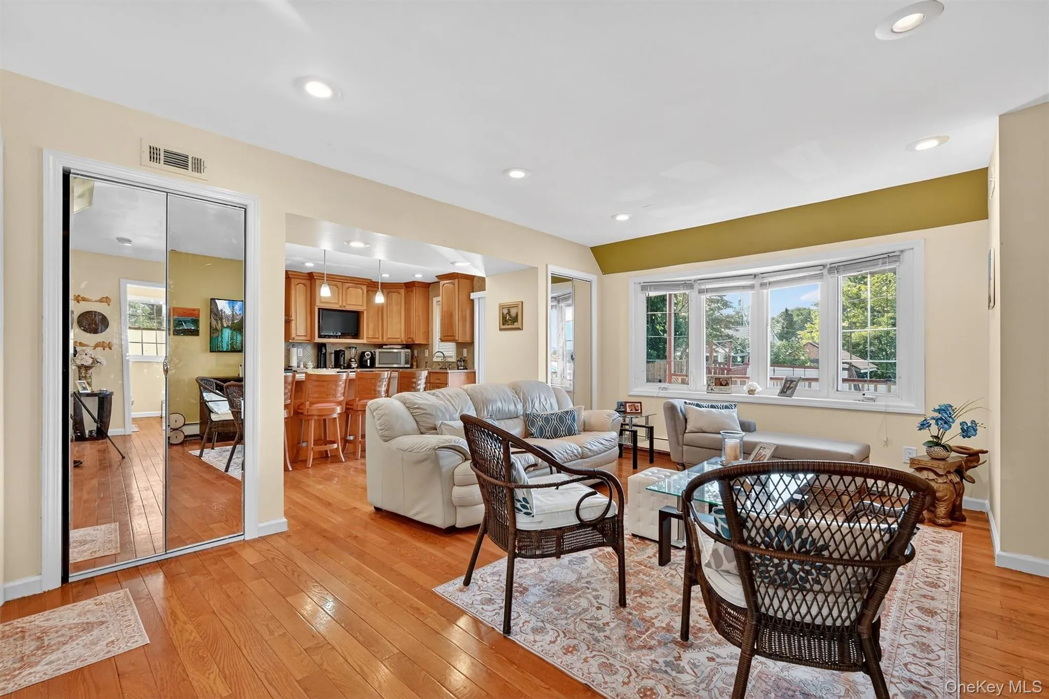 Living area with light wood-style floors and recessed lighting Living area with light wood-style floors and recessed lighting