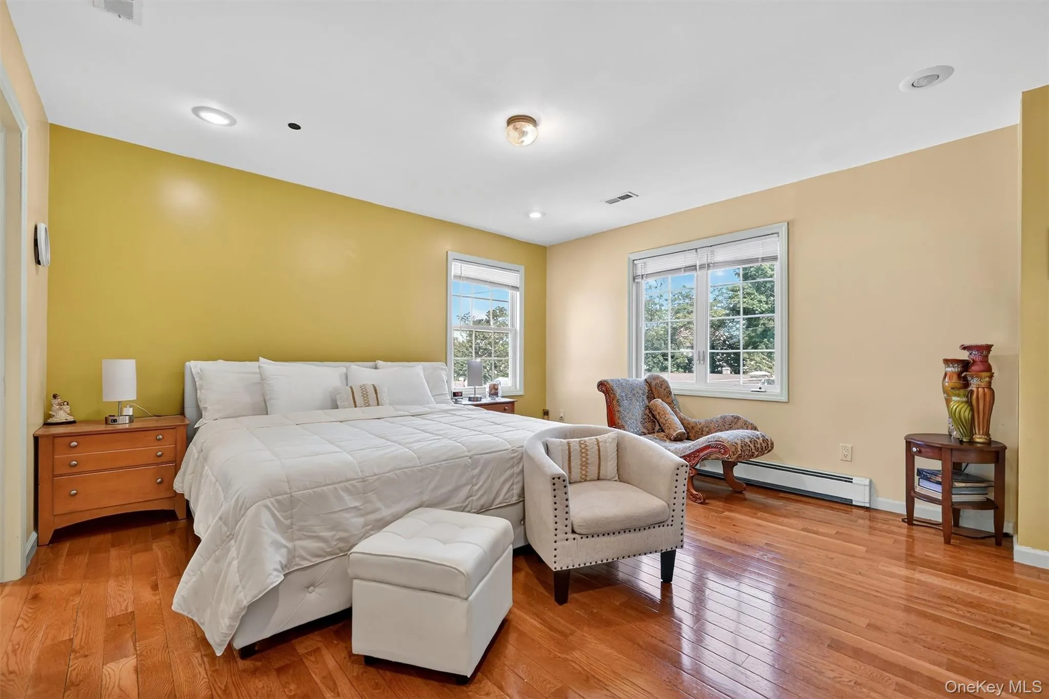 Bedroom with light wood-type flooring, baseboard heating, and recessed lighting Bedroom with light wood-type flooring, baseboard heating, and recessed lighting