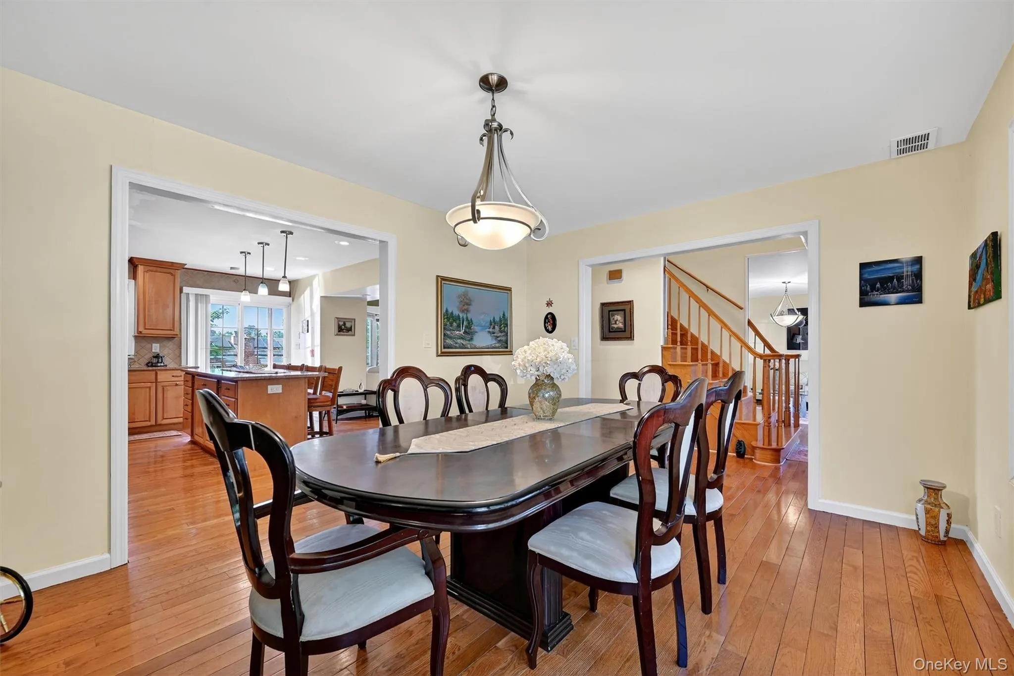 Dining space featuring wood finished floors and stairs Dining space featuring wood finished floors and stairs