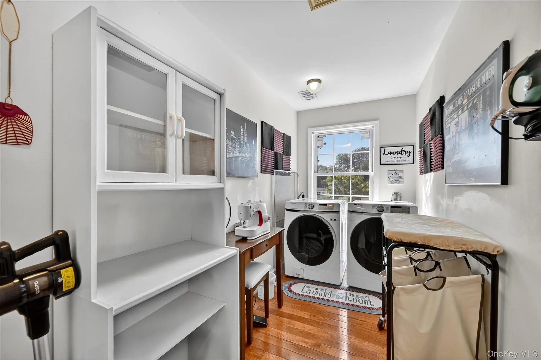 Laundry room with light wood-style floors and independent washer and dryer Laundry room with light wood-style floors and independent washer and dryer