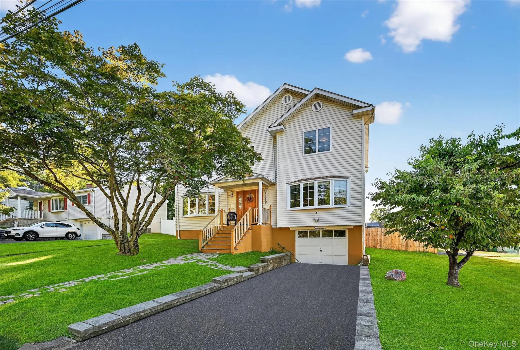 View of front facade with driveway and an attached garage View of front facade with driveway and an attached garage