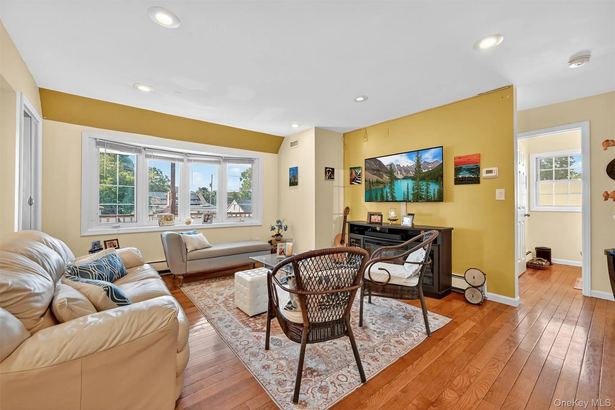 Living room featuring hardwood / wood-style floors and recessed lighting Living room featuring hardwood / wood-style floors and recessed lighting