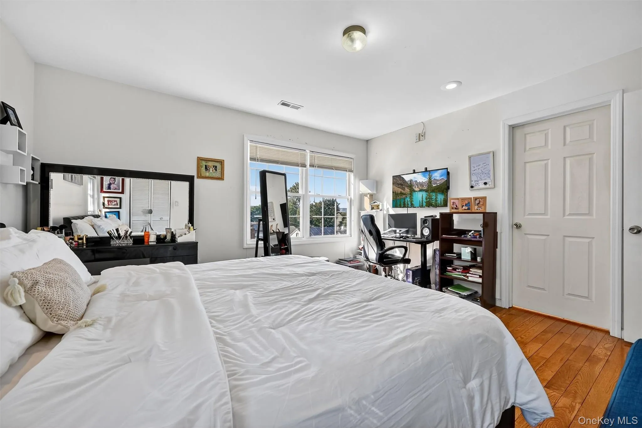 Bedroom featuring wood finished floors Bedroom featuring wood finished floors