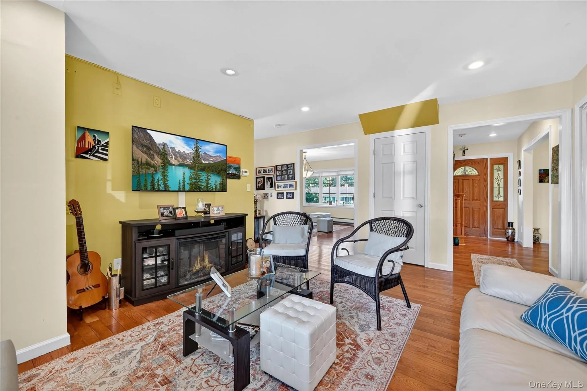 Living area with hardwood / wood-style flooring, recessed lighting, and a glass covered fireplace Living area with hardwood / wood-style flooring, recessed lighting, and a glass covered fireplace