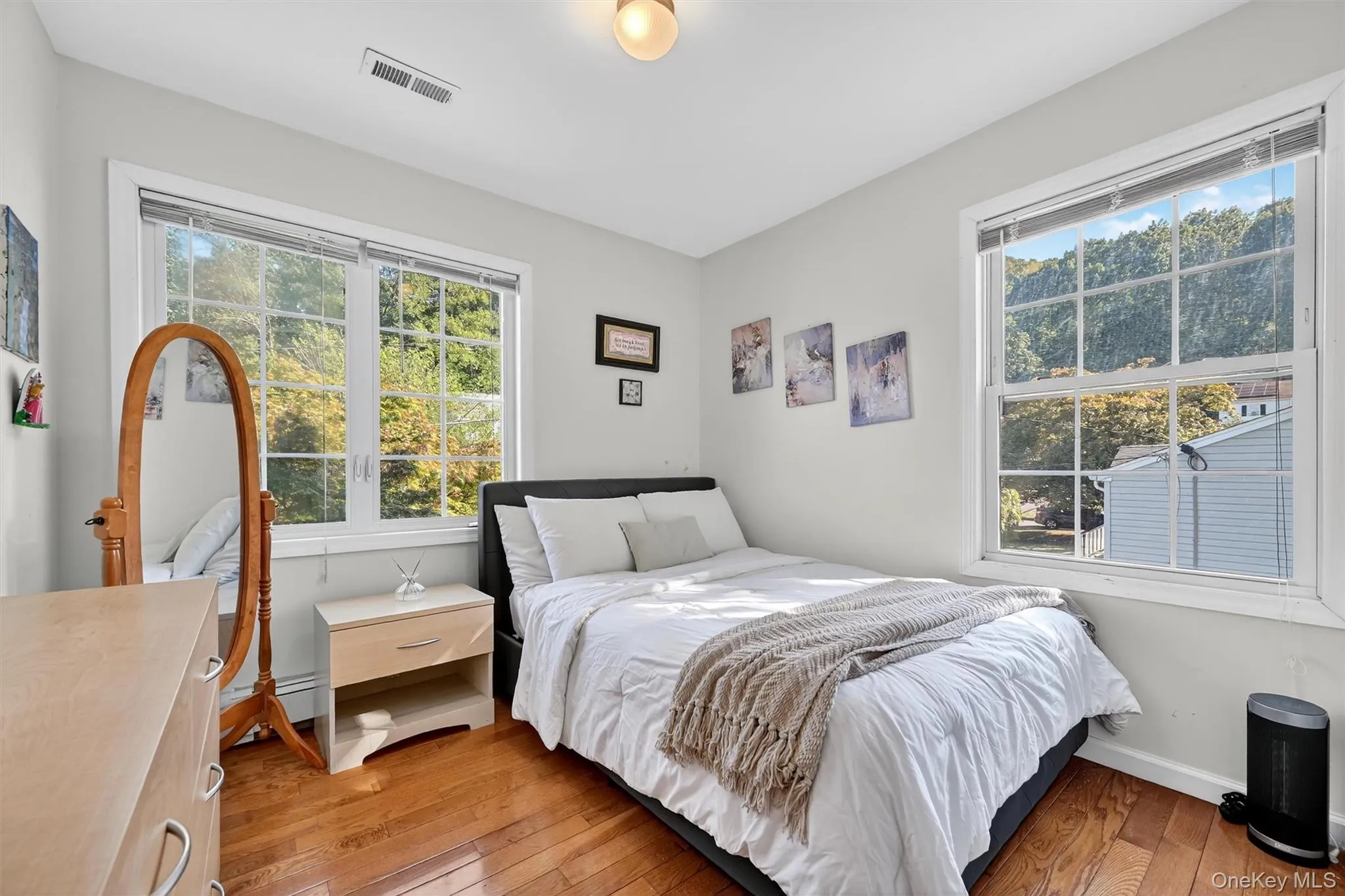Bedroom featuring light wood-style flooring and baseboards Bedroom featuring light wood-style flooring and baseboards