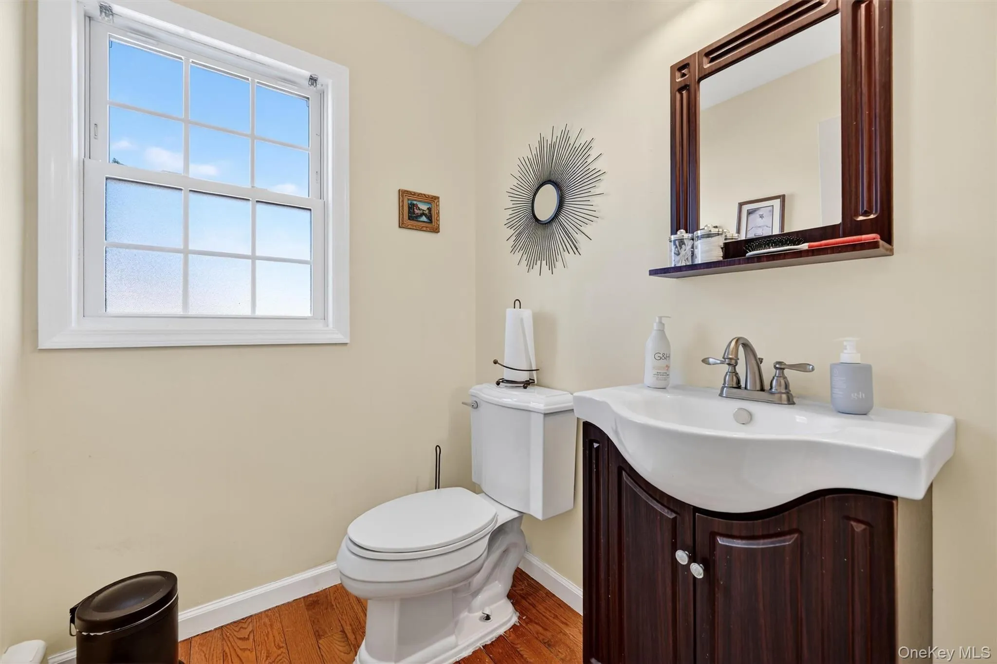 Bathroom featuring vanity and wood finished floors Bathroom featuring vanity and wood finished floors