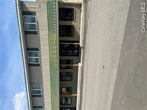 The property features a two-story building with a green metal roof accenting the first-floor overhang The property features a two-story building with a green metal roof accenting the first-floor overhang