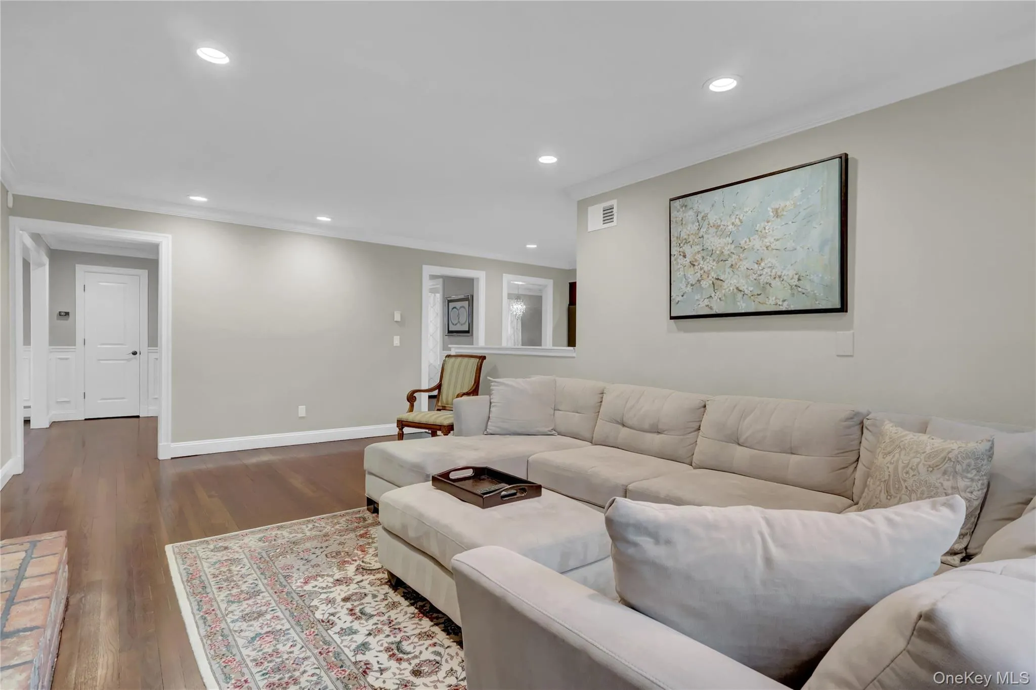 Spacious interior with dark wood-finish flooring and recessed lighting Spacious interior with dark wood-finish flooring and recessed lighting