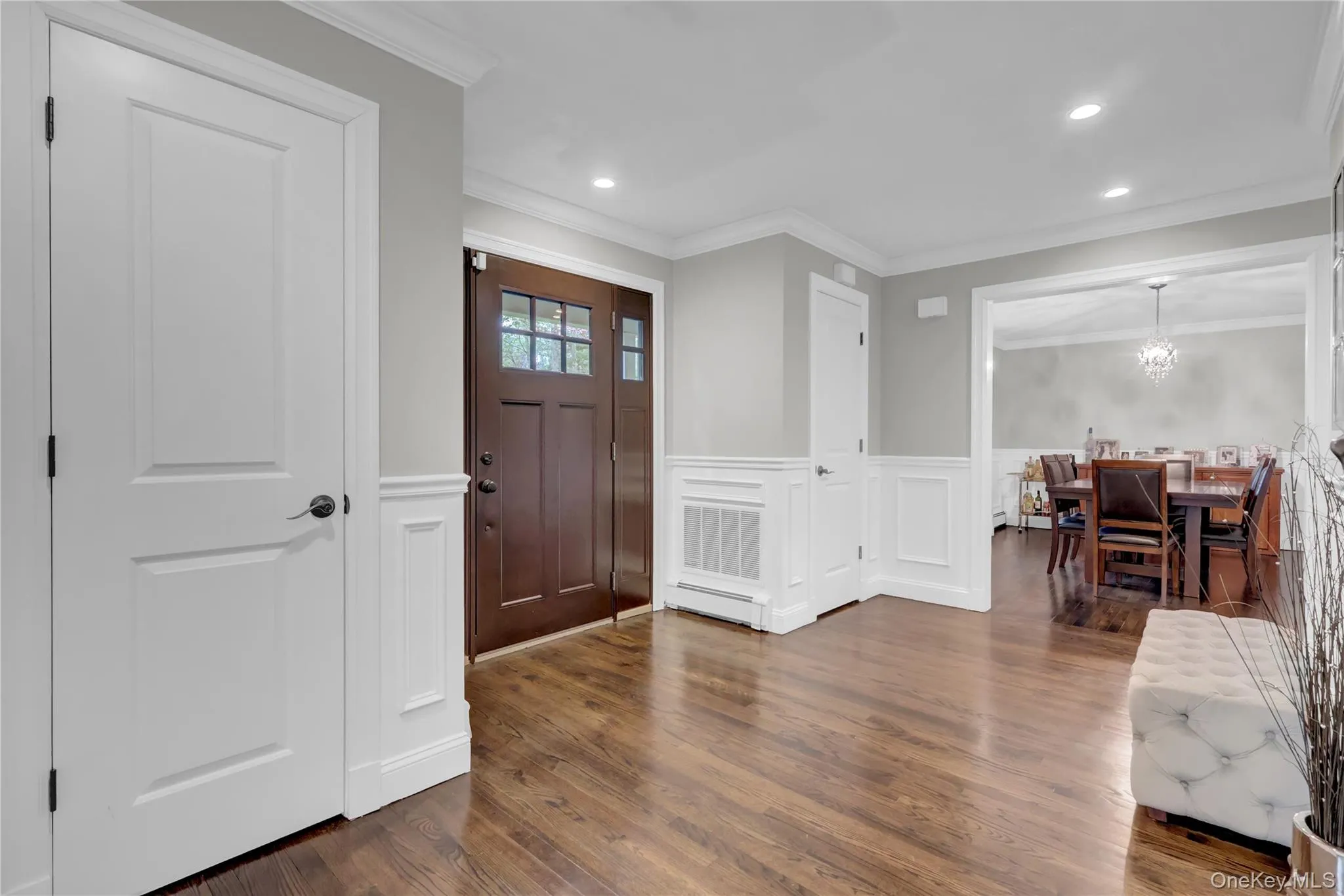 Entryway featuring rich wood-finish flooring and a craftsman-style entry door with glass panels Entryway featuring rich wood-finish flooring and a craftsman-style entry door with glass panels