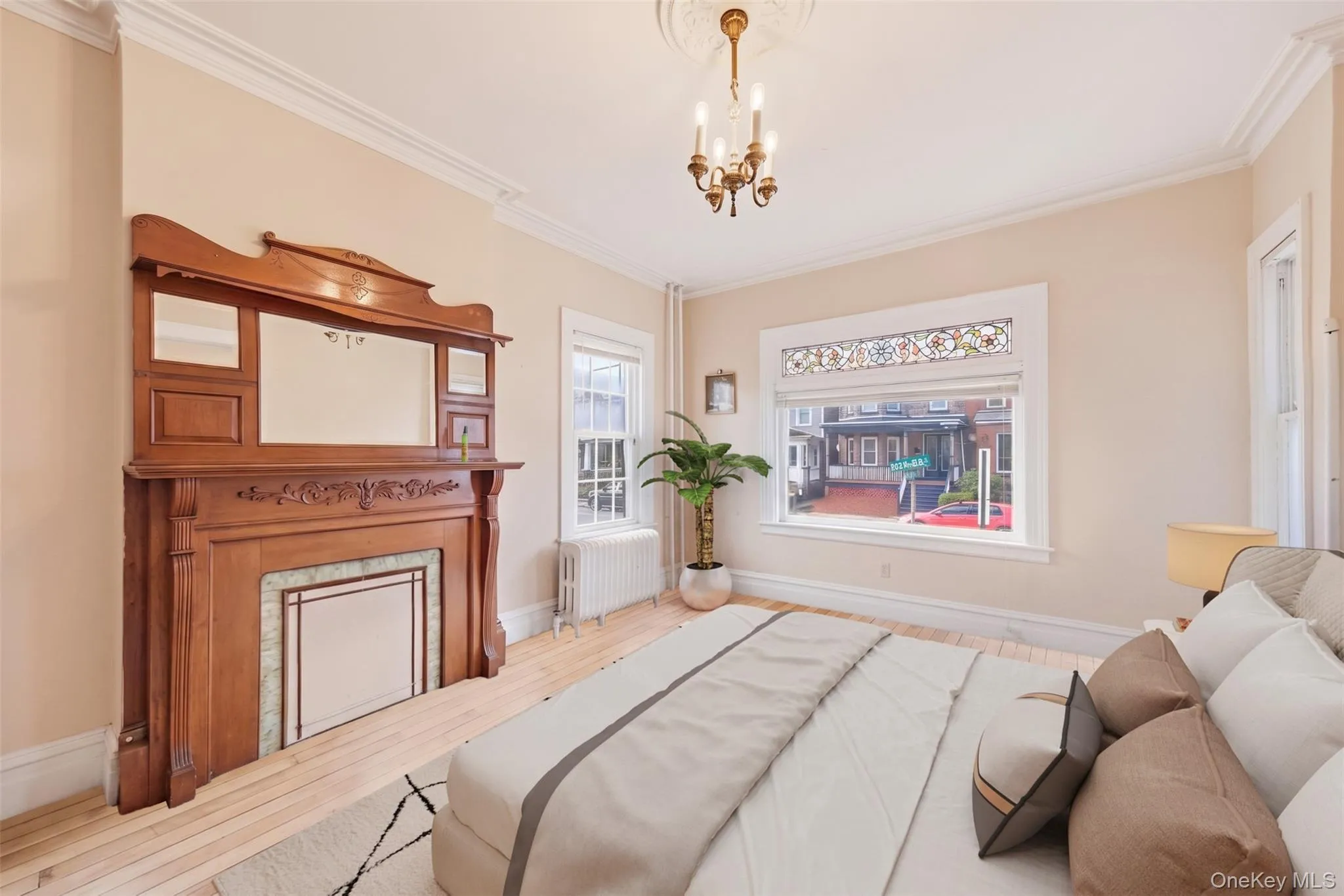Virtually Staged. Spacious primary bedroom featuring high ceilings, hardwood floors, and a beautiful decorative fireplace. Virtually Staged. Spacious primary bedroom featuring high ceilings, hardwood floors, and a beautiful decorative fireplace.