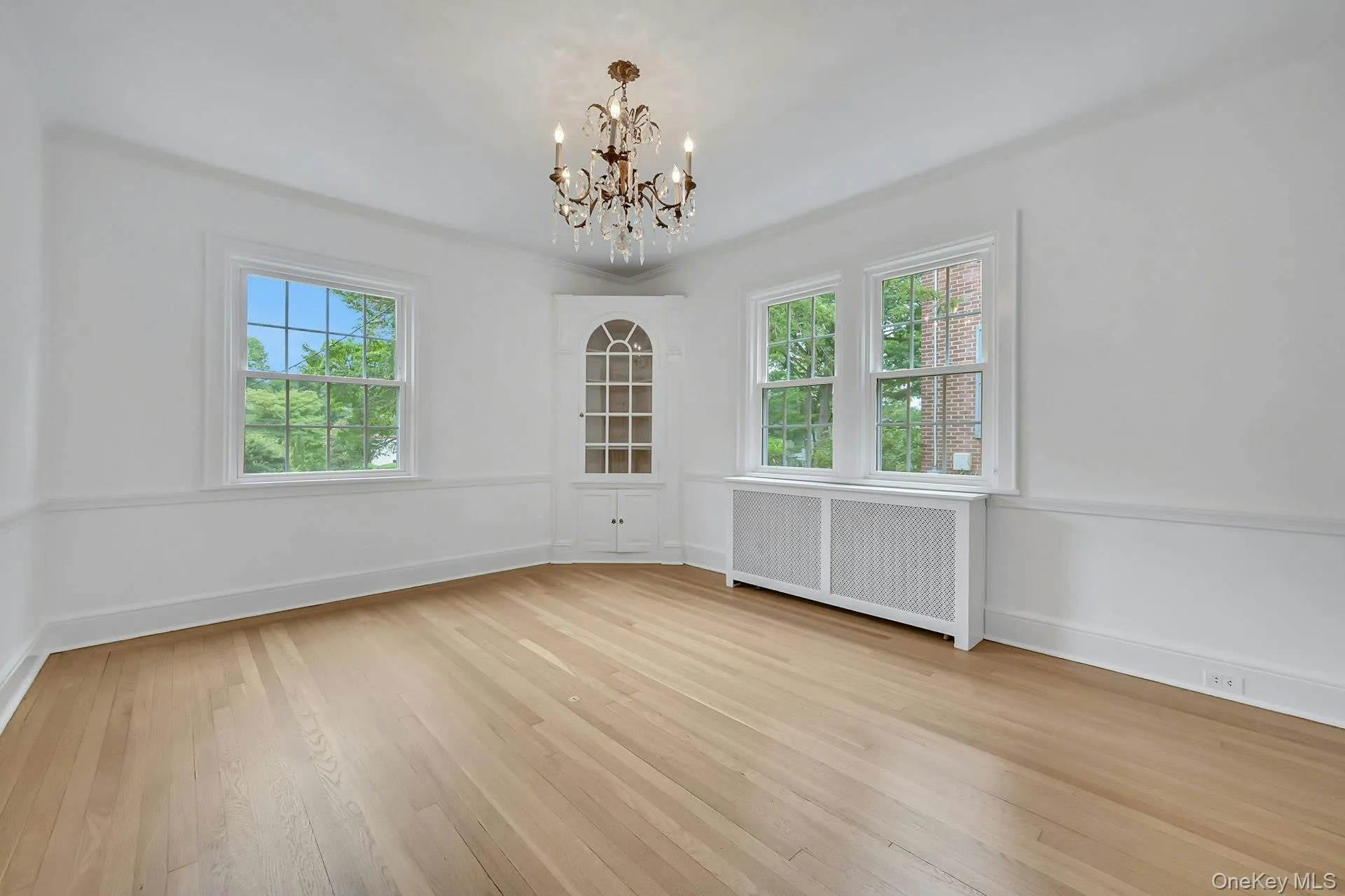 Formal dining room featuring corner china cabinet and dual window exposures Formal dining room featuring corner china cabinet and dual window exposures