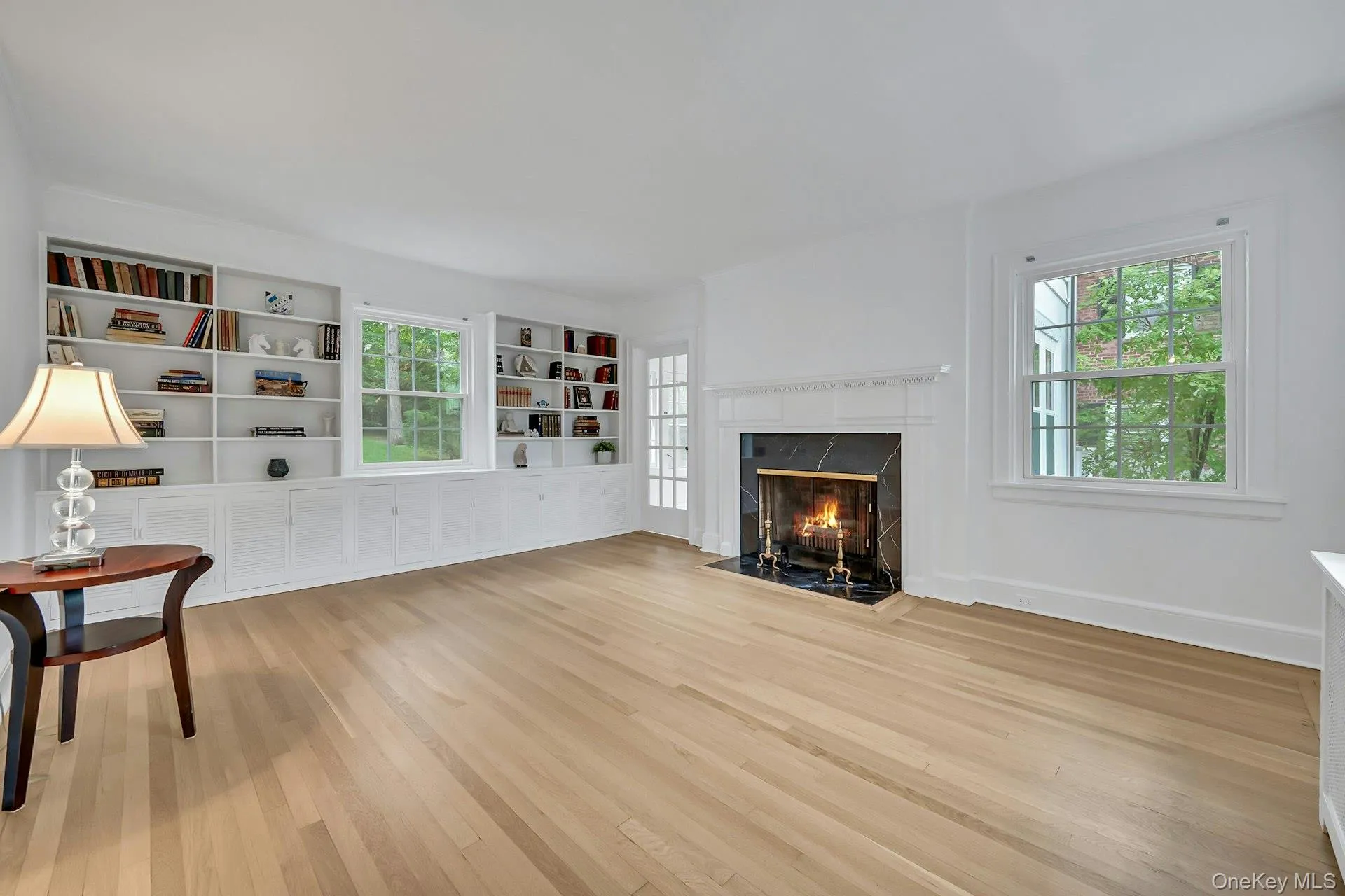 Classic living room with built-ins, fireplace, and convenient bonus room entry Classic living room with built-ins, fireplace, and convenient bonus room entry