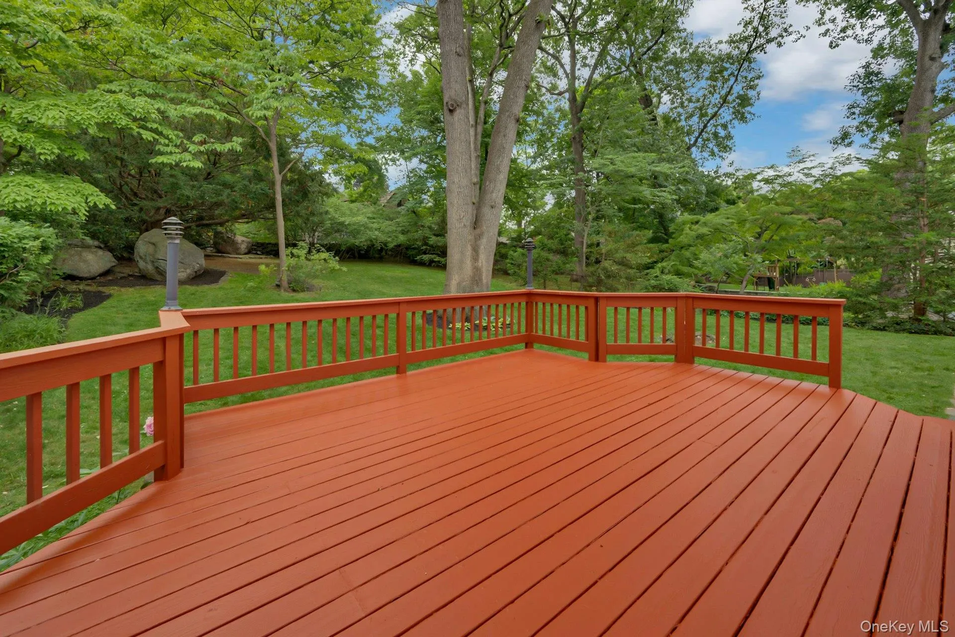 Well-designed redwood-stained deck with backyard views Well-designed redwood-stained deck with backyard views