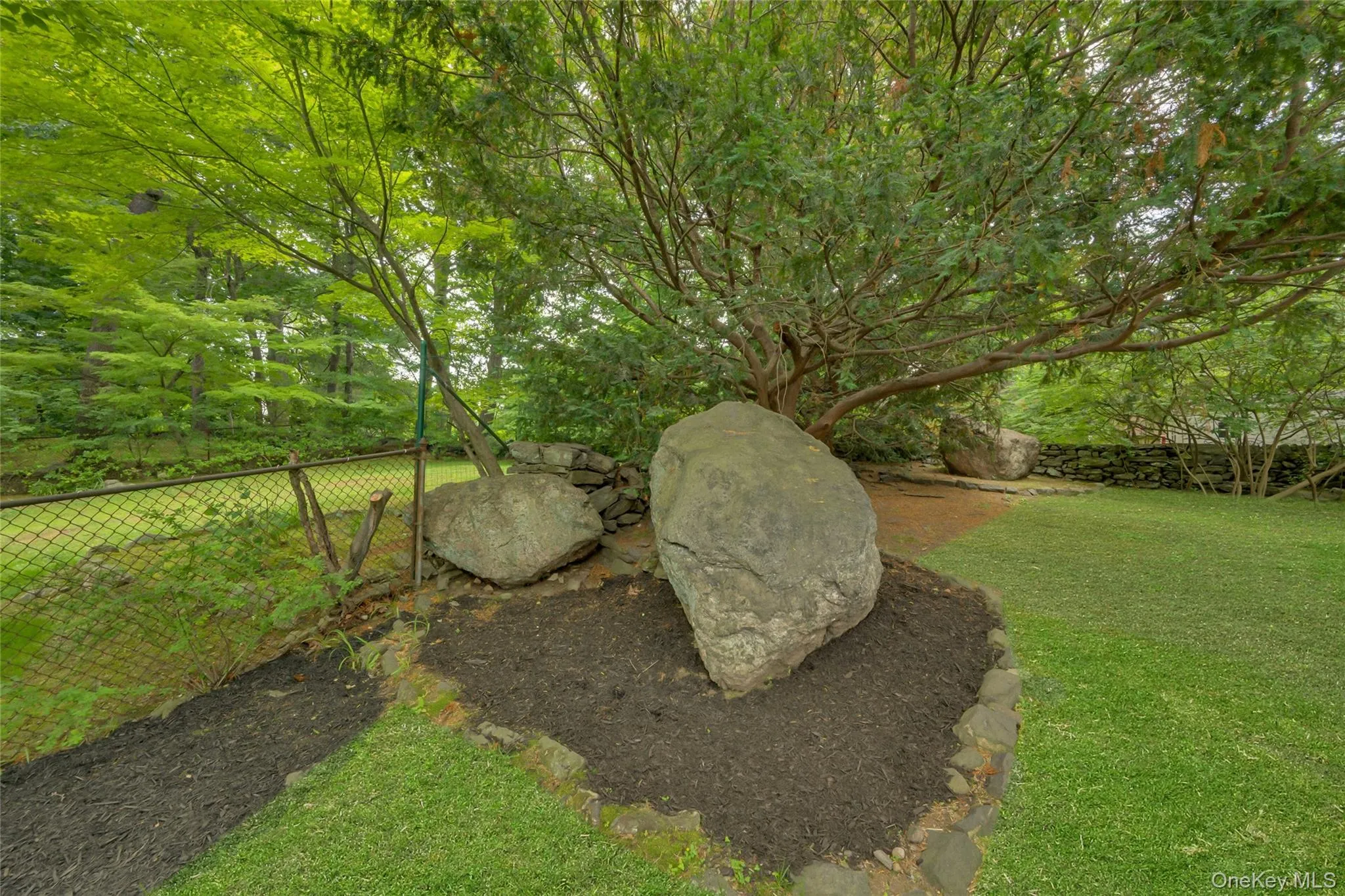 Natural stone outcroppings add character to the property Natural stone outcroppings add character to the property