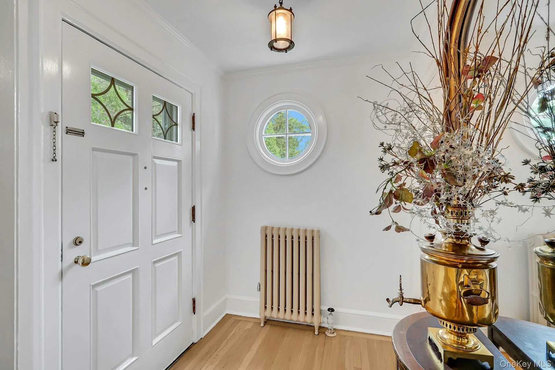 Classic center hall foyer highlighted by a beautiful circular window Classic center hall foyer highlighted by a beautiful circular window