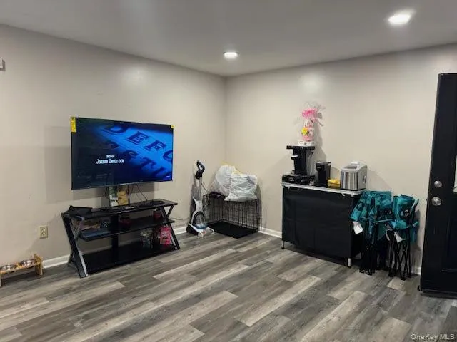 Living area with wood finished floors, recessed lighting, and baseboards Living area with wood finished floors, recessed lighting, and baseboards